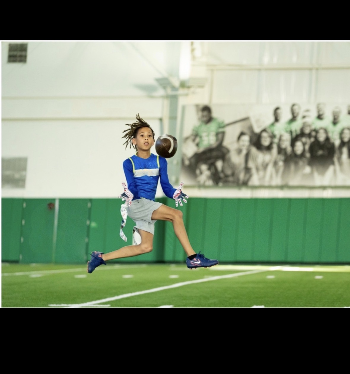 Morgan catching a football while competing in flag football